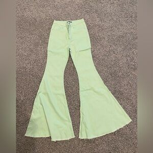 Fashion Nova pastel green bell bottom flare jeans.